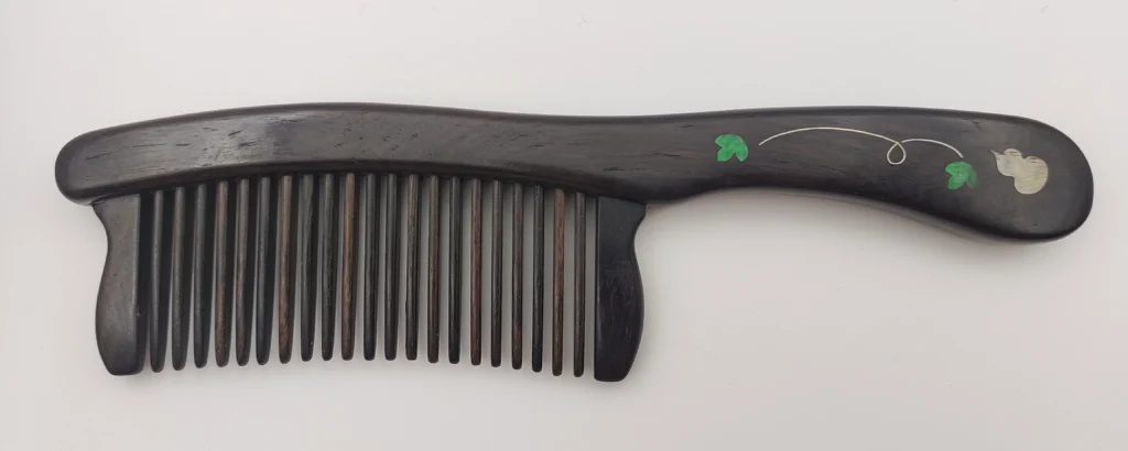 This sandalwood comb features delicate mother‑of‑pearl inlay, exuding a classic elegance that reflects Eastern aesthetics. Its finely polished, rounded teeth are gentle on both hair and scalp, helping prevent static while providing a soothing massage that supports healthy hair.